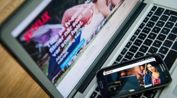 Netflix streams on a laptop and cellphone. The video- streaming service is responsible for 35 percent of bandwidth usage in North America, according to a recent study.