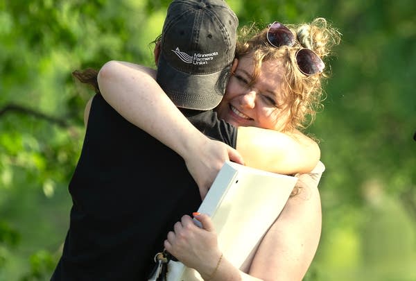 Two people hugging outside