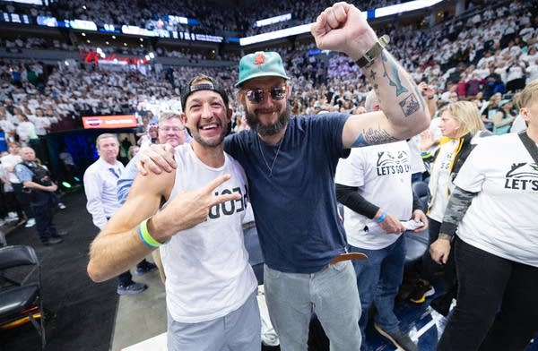People pose for a photo at a basketball game-2