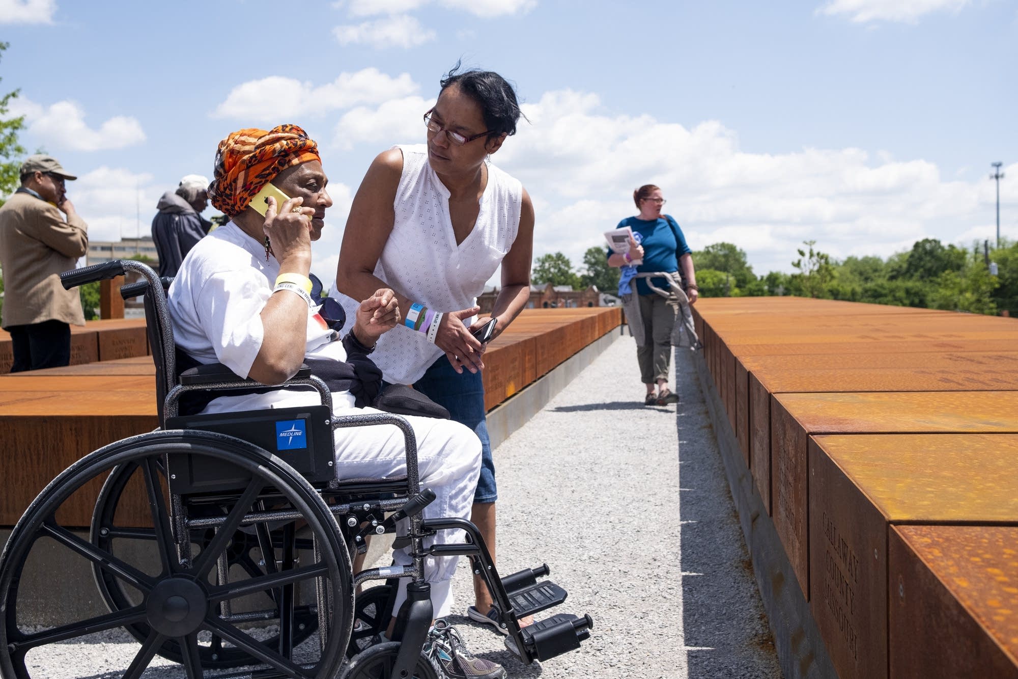 Portia Johnson talks to her grandson on the phone alongside Kim Green.