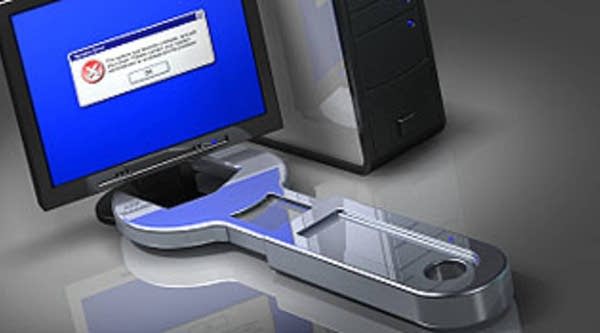 A wrench around a computer represents online crime and Internet security.