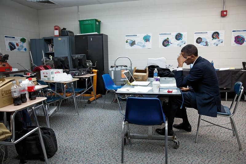 Obama sits alone speaking at a memorial for Sandy Hook victims.