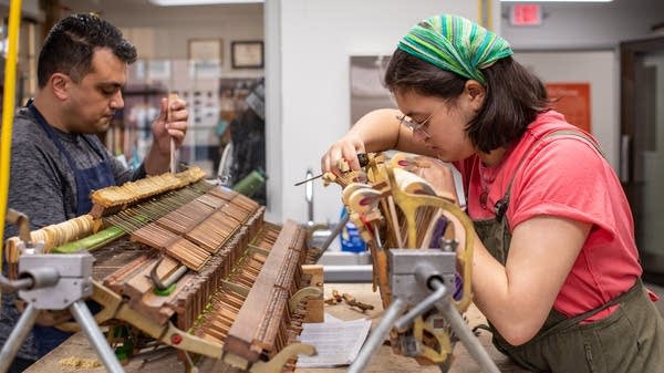 Basic Piano Technology students working on piano action