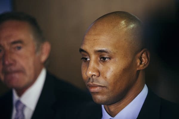 Mohamed Noor is lit by television cameras.