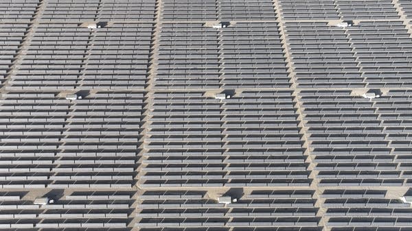 An aerial view of hundreds of solar panels.