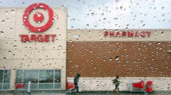A couple of shoppers leave a Target store on a rainy afternoon in Alhambra, California.