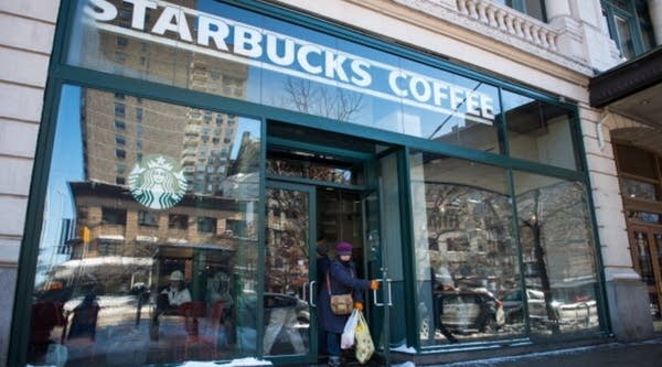Customers exit a Starbucks location in New York.
