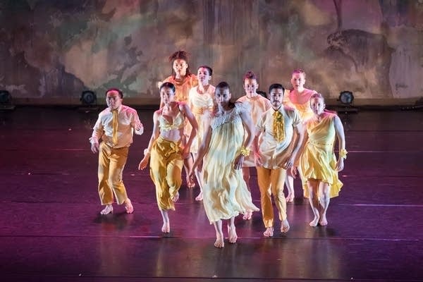 A group of dancers performs together on stage.