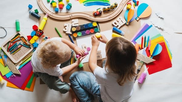 Children at a day care playing with toys.