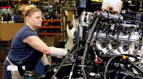  A woman works on GM truck engine on the assembly line of the General Motors Flint Assembly Plant January 24, 2011 in Flint, Michigan.