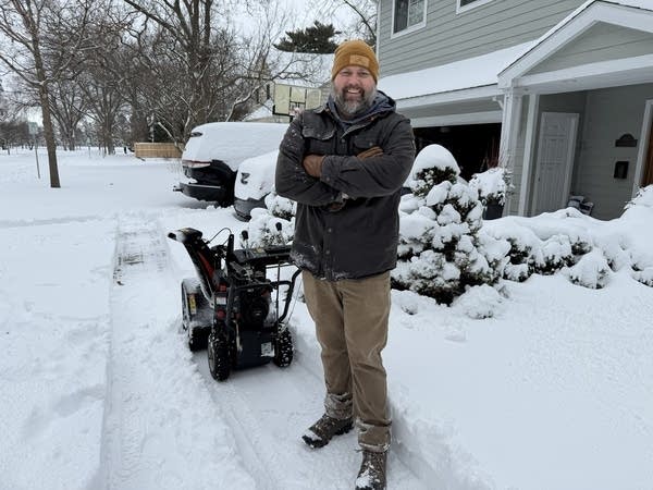Adam Carlson, 44, uses his snowblower machine to clear walkways Mar. 15 in Rochester. 