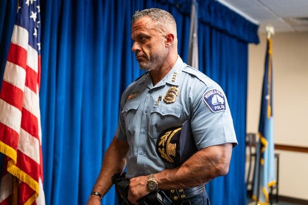 A police chief walks out of a room