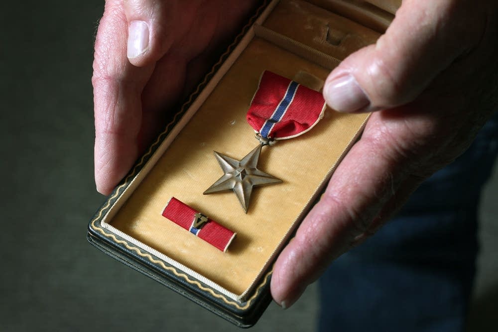 Galen Bungum holds the bronze star he was awarded.
