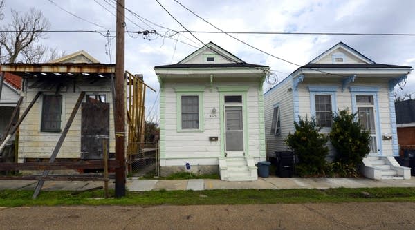A vacant home (left) stands next to two rebuilt houses in the Lower Ninth Ward of New Orleans back in 2013.