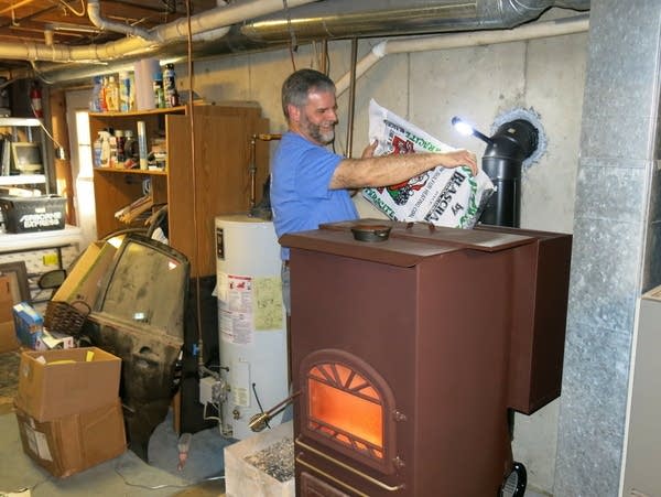 John Ord loads a hopper on the back of his coal-burning stove