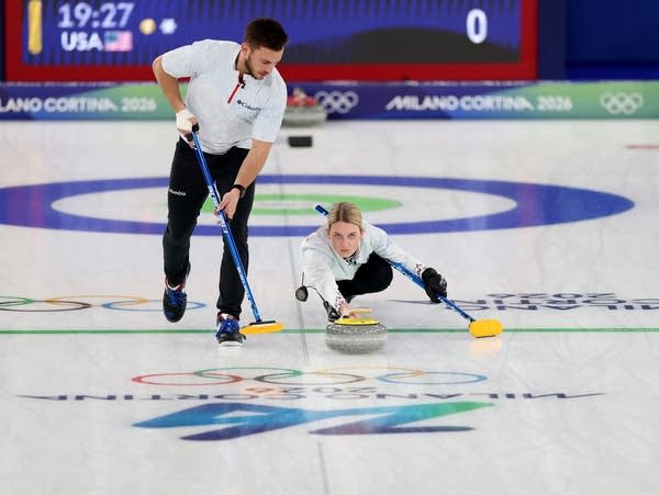 Two curlers compete in a match