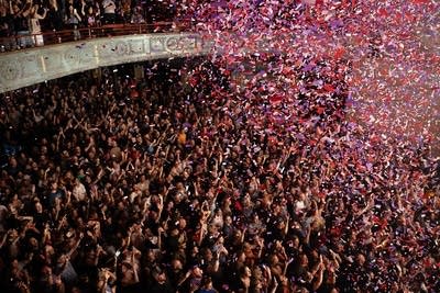 Confetti descends on a music venue filled with music fans 