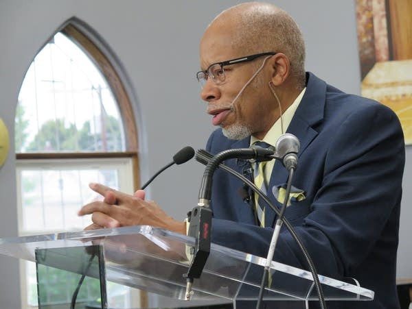 Pastor William Land speaks to the congregation