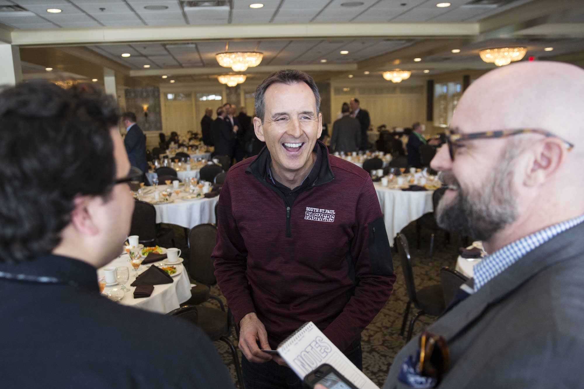 Tim Pawlenty laughs with reporters after giving a speech
