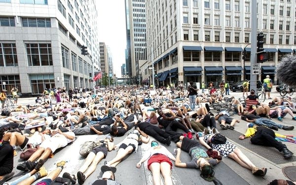 people lying on the road downtown in demonstration