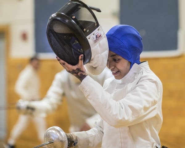 Ekhlas Abdullahi slips on her mask before sparring.