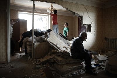 Georgians in a house destroyed by a Russian bomb.