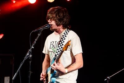 Man playing guitar and singing on stage