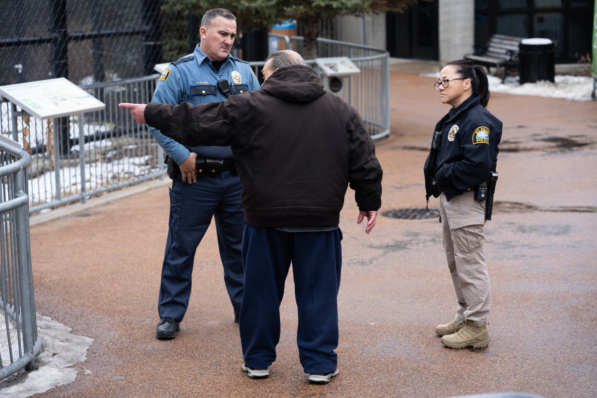 St. Paul police officers Matthew Arntzen and Lori Goulet talk to a man.