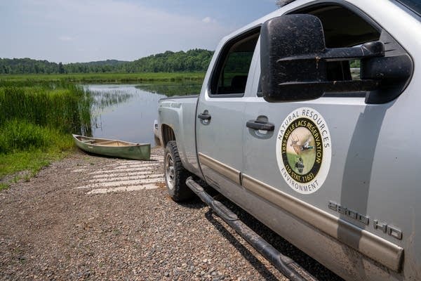 a truck is parked in front of a field