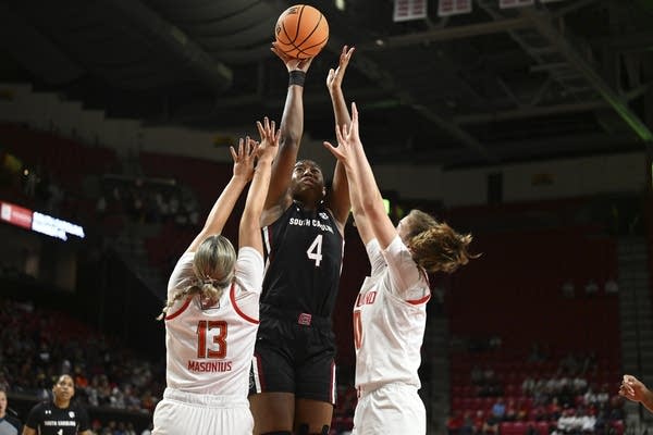 Player in dark jersey rises above others 