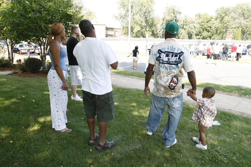 Crowd looks at crime scene