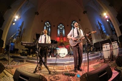 Two musicians performing onstage