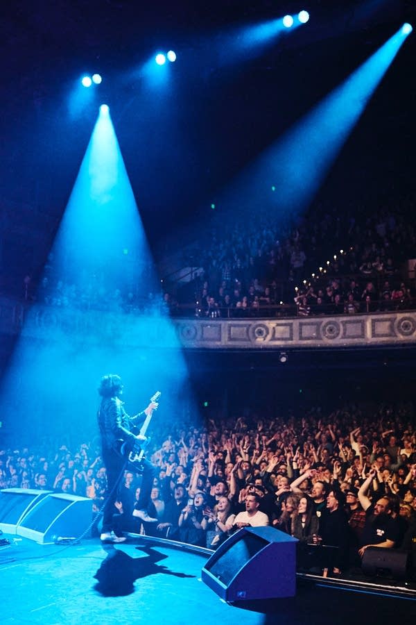 Jack White holds an electric guitar onstage looking out at the crowd at Palace Theatre.