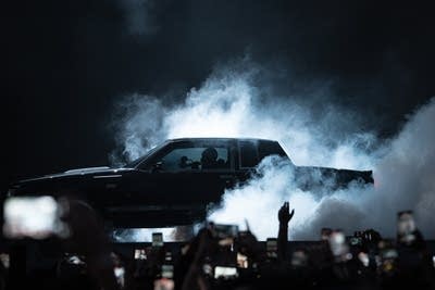 Car on stage surrounded by smoke