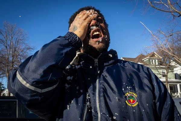 A man wipes his face