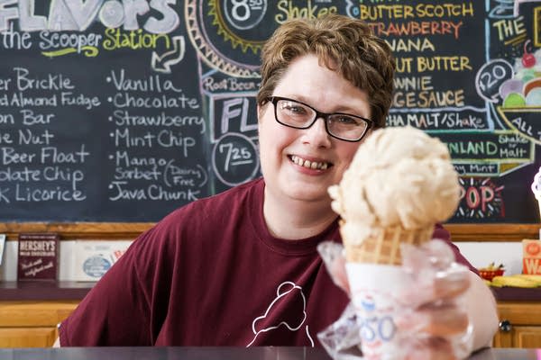 A woman holds an ice cream cone