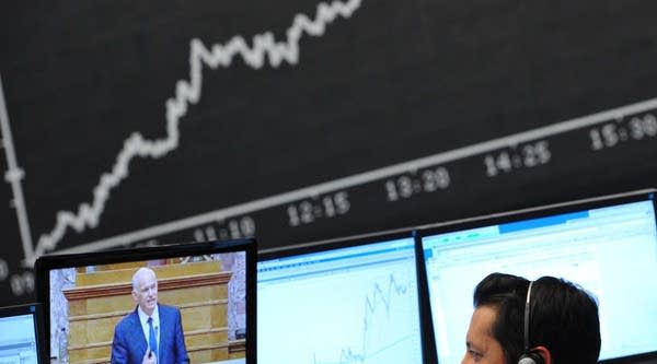 A trader follows the speech by Greek Prime Minister George Papandreou on a television at the stock exchange in Frankfurt am Main, Germany, on November 3, 2011. 