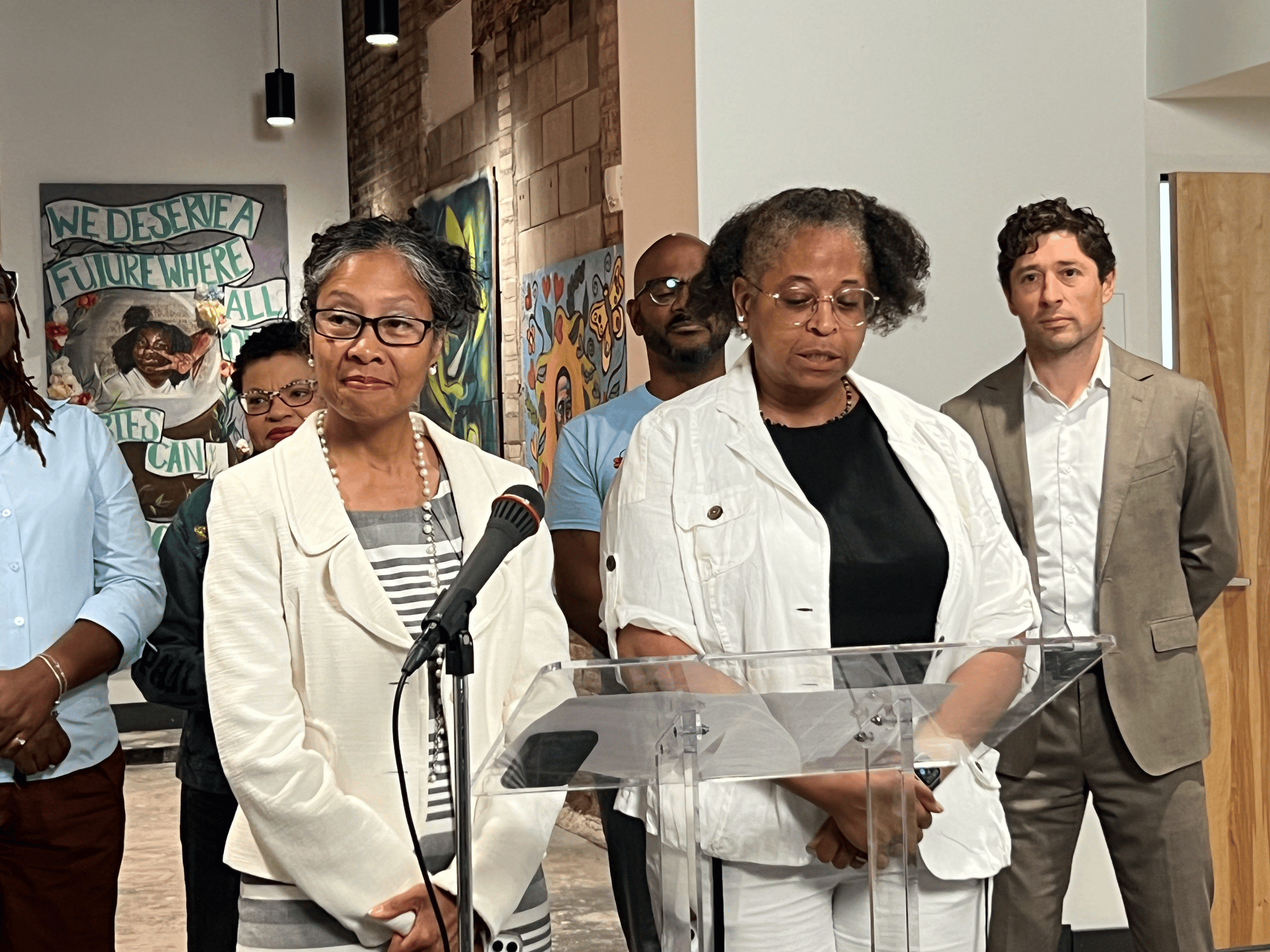 People speak at a podium