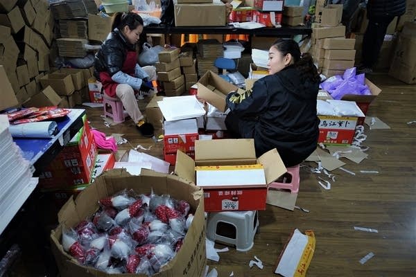 Workers at Vastsee's Shanghai warehouse packing items destined mainly for the U.S. and Europe. Overall sales to America have dropped since the U.S. postal rates increased. (Charles Zhang/Marketplace)