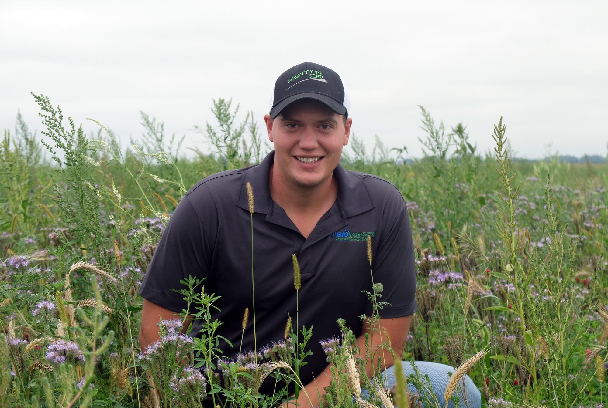 LaMoure, N.D., farmer Kasey Bitz poses in a field of pollinator habitat.