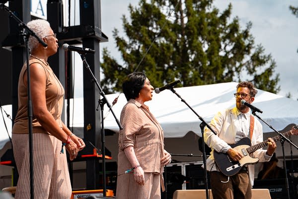 The union and phil cook performing on an outdoor stage