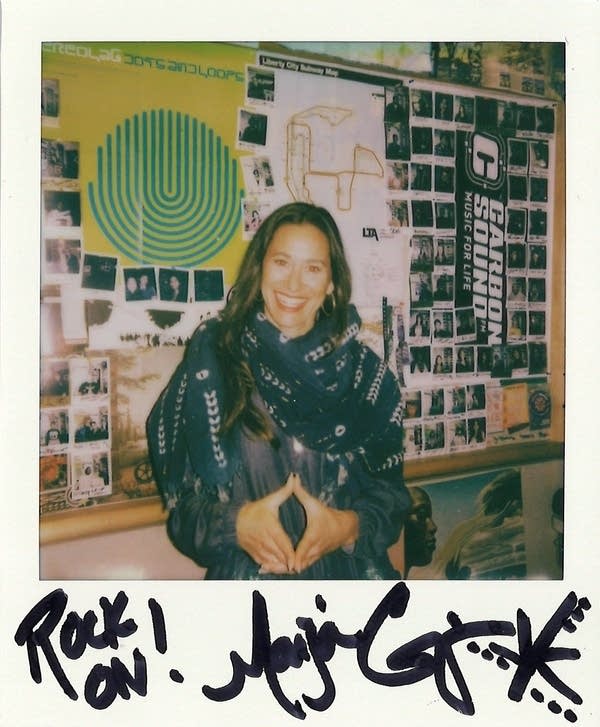 a signed polaroid with a woman in it
