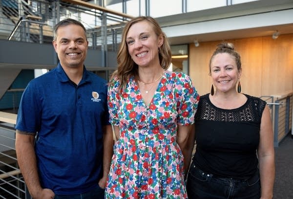 three people posing for a portrait