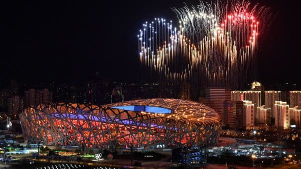 Fireworks form the Olympic rings over Beijing's National Stadium on Friday. Human rights advocates have pressured advertisers to cancel sponsorships because of accusations of abuses.