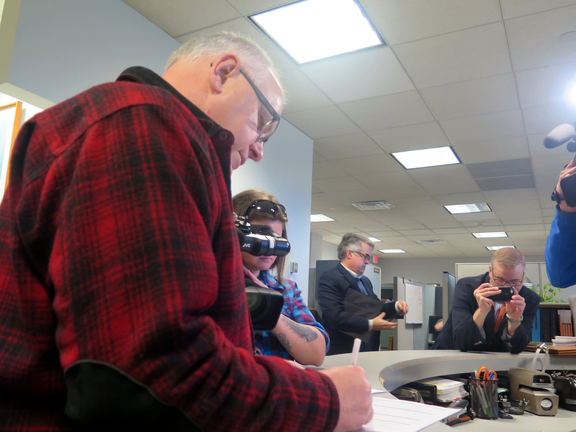 Tim Walz signs paperwork creating a campaign account for governor
