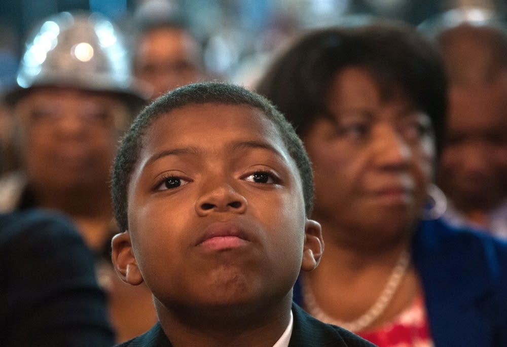 A boy listens Romney