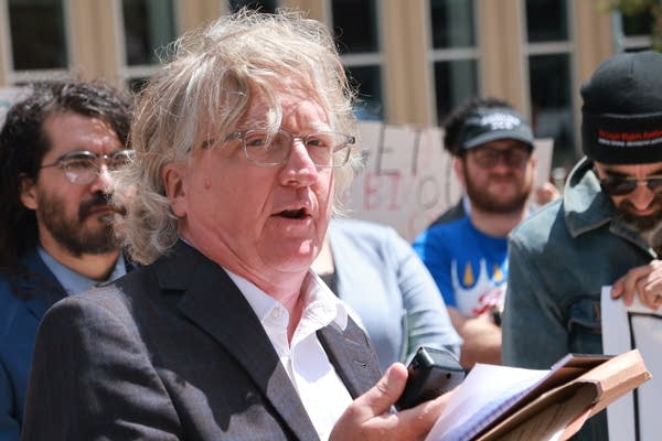 attorney speaks outside courthouse at rally