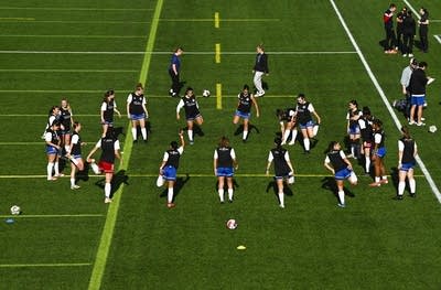 players warming up on soccer field