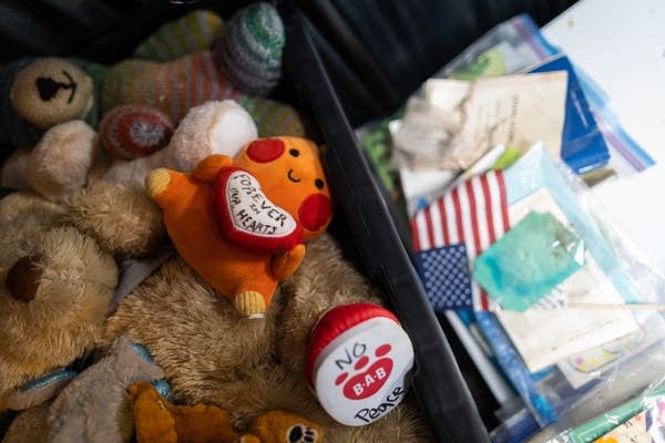 Stuffed animals in a bin