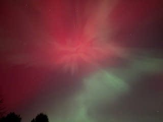 Red and green lights in a night sky.